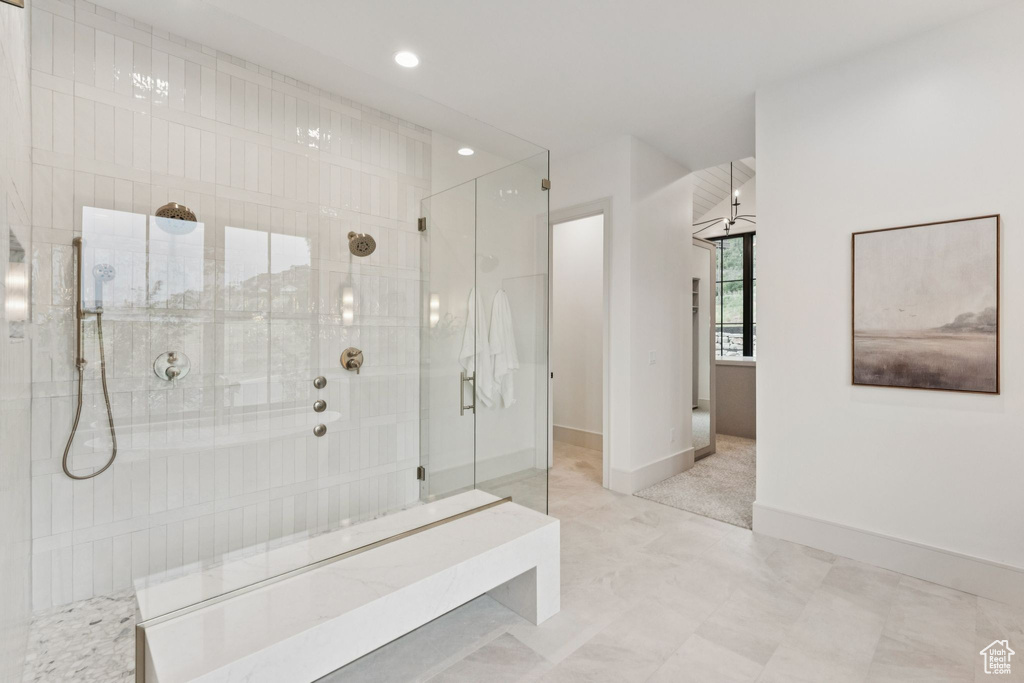 Full bathroom featuring tiled shower and recessed lighting