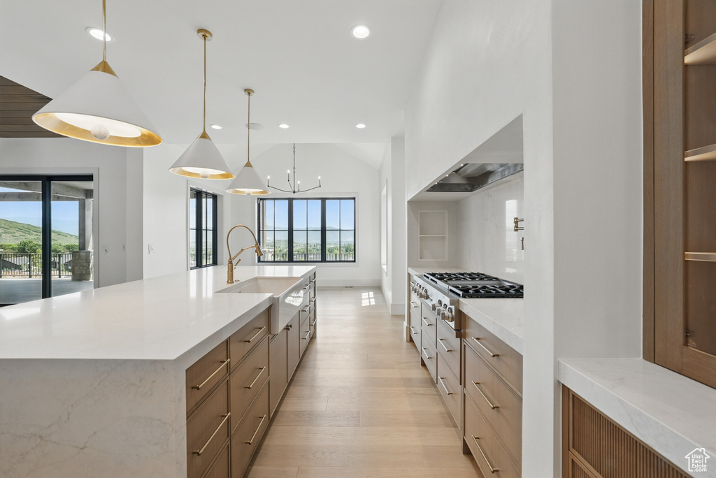 Kitchen with stainless steel gas stovetop, modern cabinets, light wood-style flooring, recessed lighting, and a sink