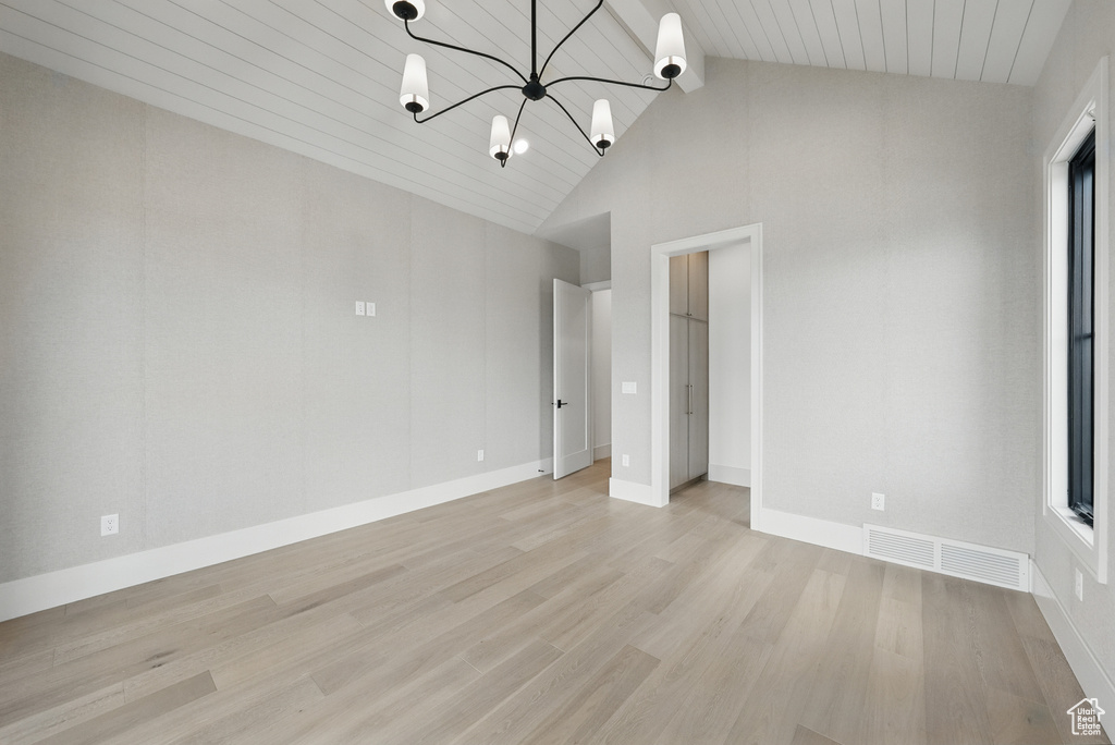 Unfurnished bedroom with light wood finished floors, a chandelier, baseboards, high vaulted ceiling, and wooden ceiling with exposed beams