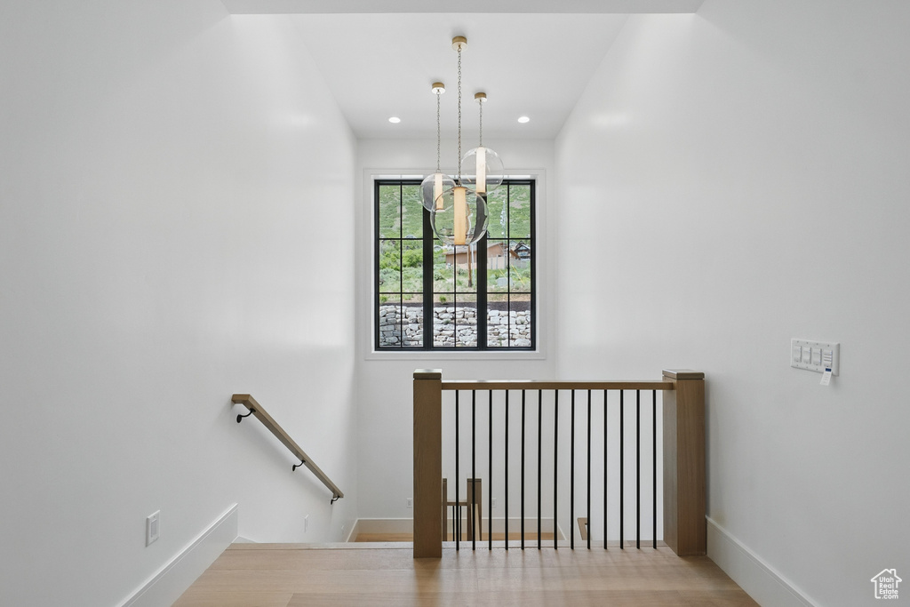 Staircase featuring recessed lighting and wood finished floors