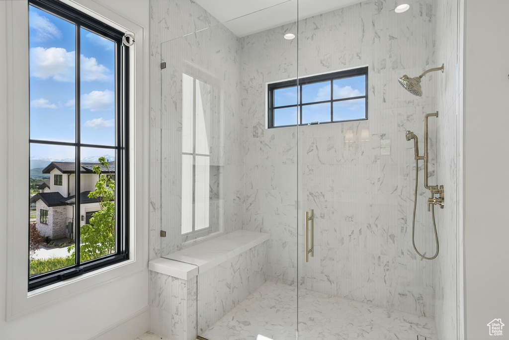 Bathroom featuring a marble finish shower