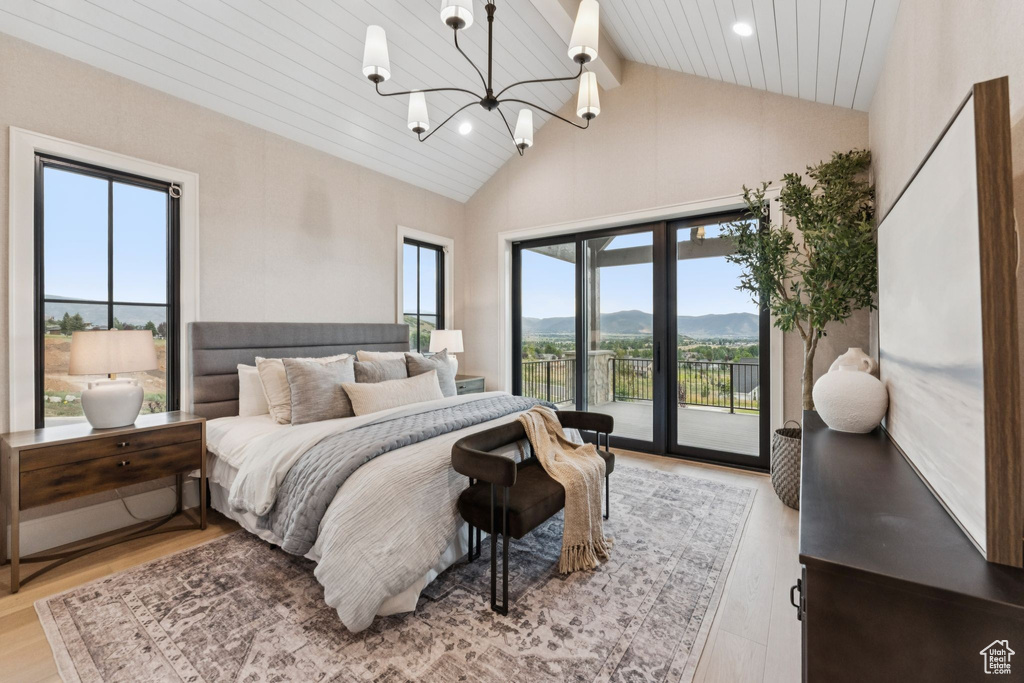 Bedroom featuring access to exterior, a mountain view, light wood-type flooring, recessed lighting, and a chandelier