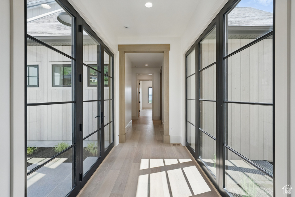 Corridor featuring wood finished floors and recessed lighting
