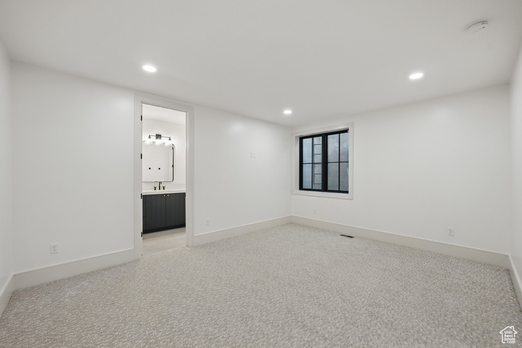 Empty room with recessed lighting, light carpet, and a smoke detector