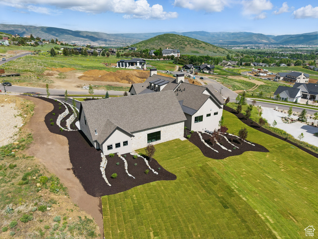 Aerial view of property and surrounding area with mountains