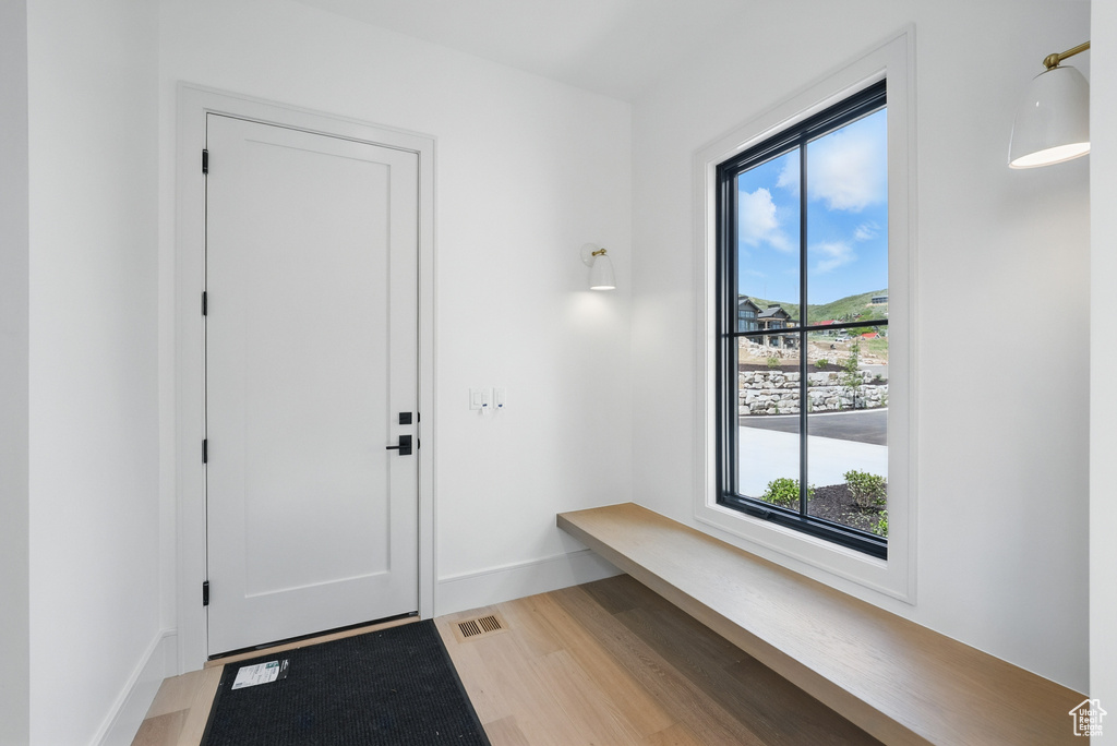 Mudroom featuring light wood-style floors and baseboards