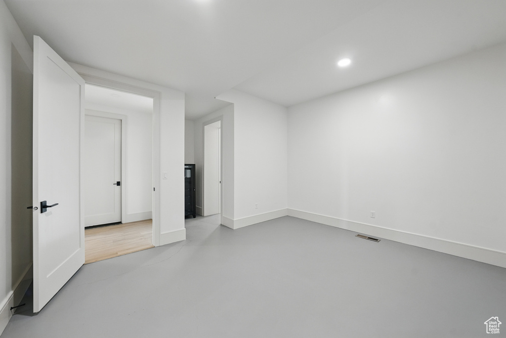Empty room with recessed lighting, finished concrete floors, and baseboards