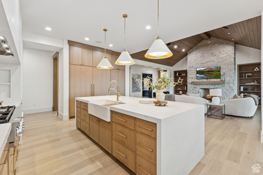 Kitchen with light wood-style flooring, recessed lighting, wooden ceiling, built in features, and modern cabinets
