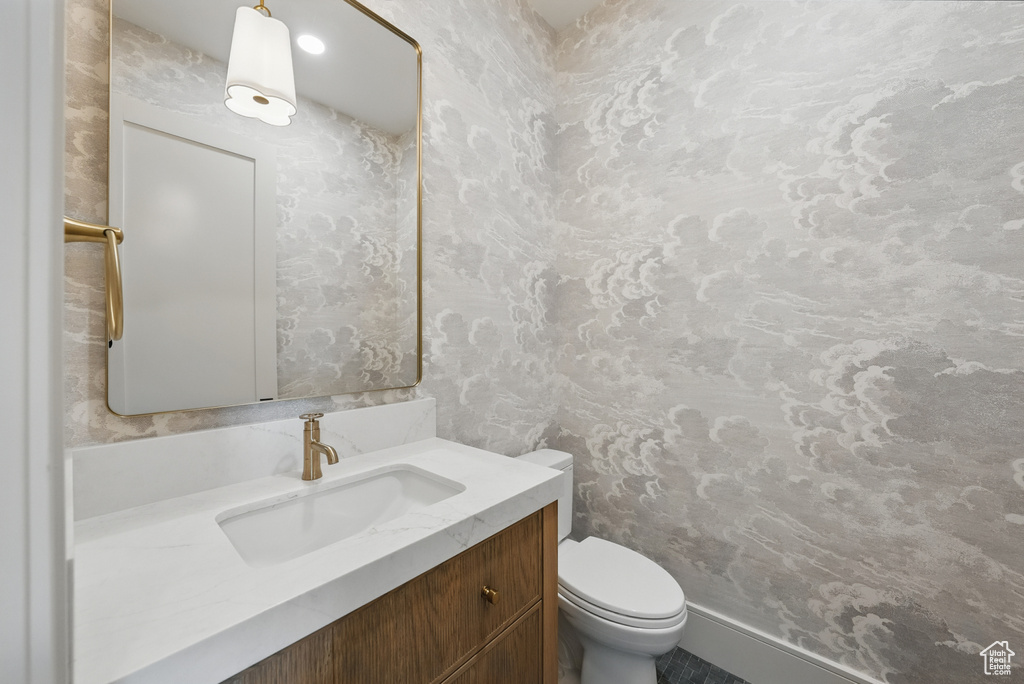 Half bathroom with vanity and toilet