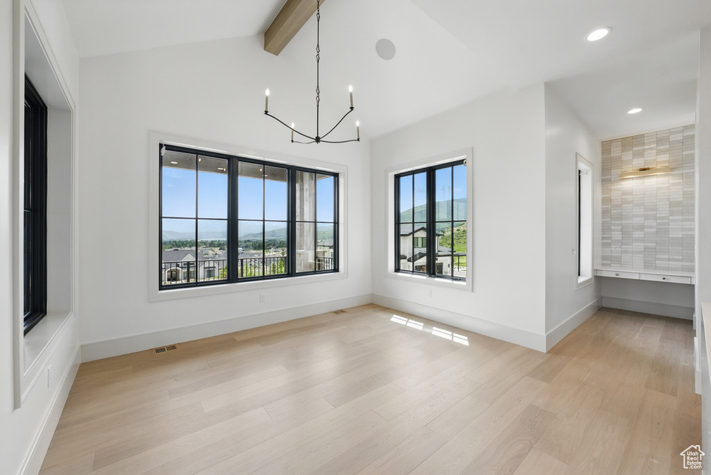 Spare room with light wood-style flooring, a chandelier, baseboards, and recessed lighting