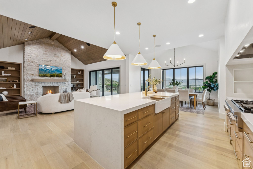 Kitchen featuring plenty of natural light, light wood finished floors, high vaulted ceiling, wood ceiling, and stainless steel gas stovetop
