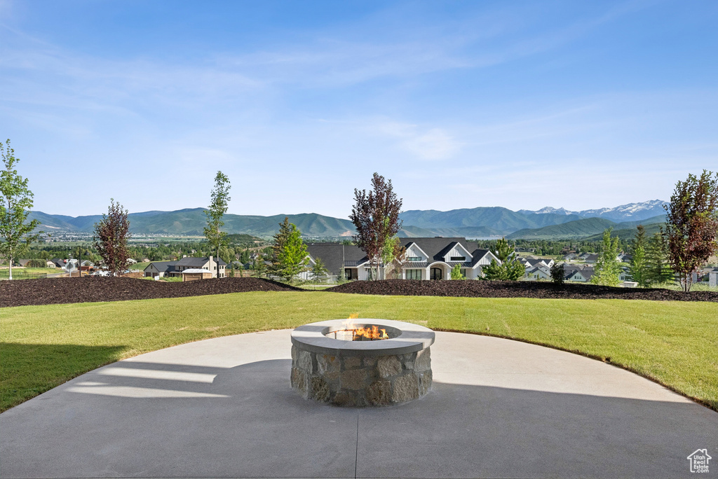 View of patio featuring a fire pit and a mountain view