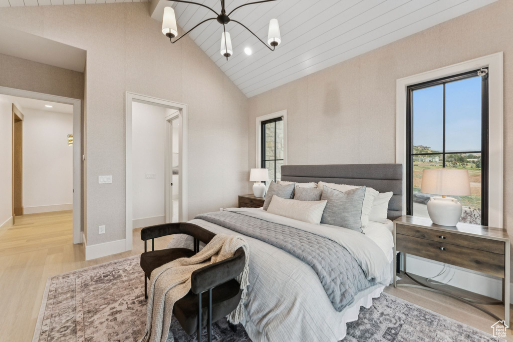 Bedroom with light wood-type flooring, a chandelier, beamed ceiling, recessed lighting, and high vaulted ceiling