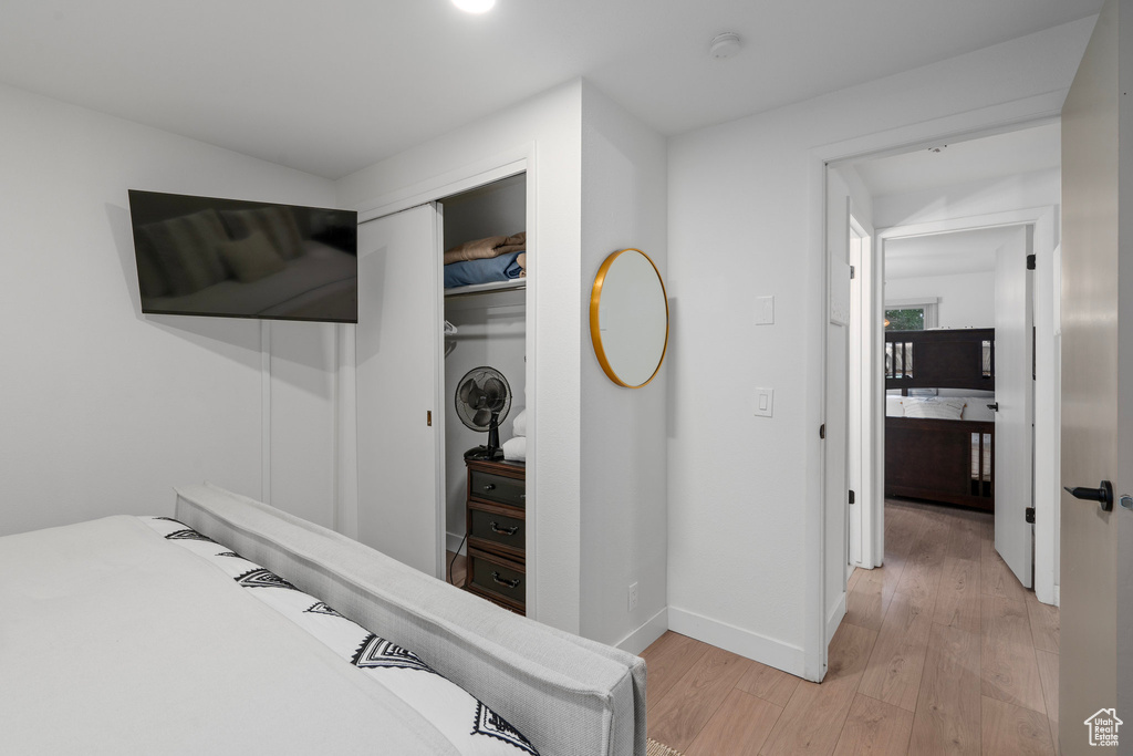 Bedroom featuring a closet and light hardwood / wood-style floors