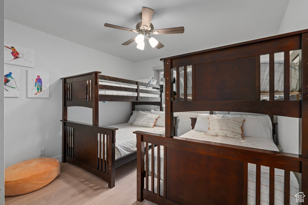 Bedroom with light hardwood / wood-style flooring and ceiling fan