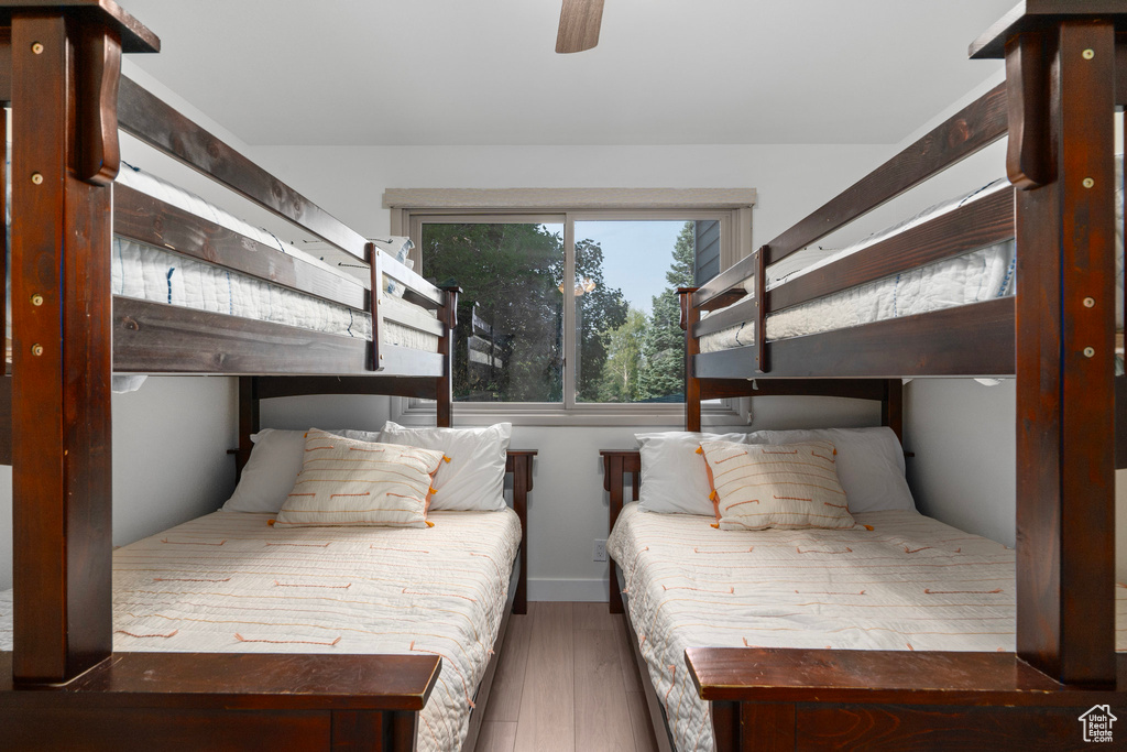 Bedroom featuring dark wood-type flooring and ceiling fan