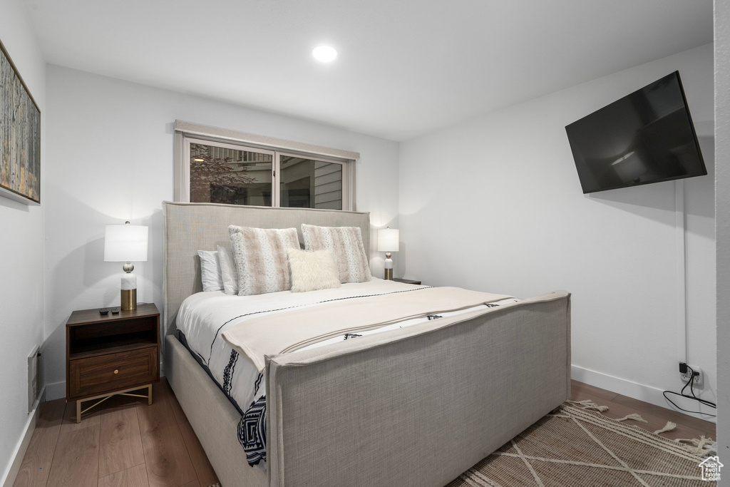 Bedroom with dark wood-type flooring