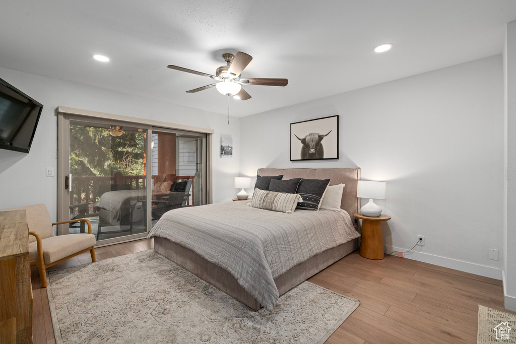 Bedroom with light wood-type flooring, access to outside, and ceiling fan