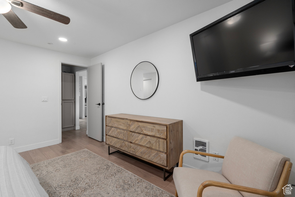 Sitting room featuring ceiling fan and light hardwood / wood-style flooring