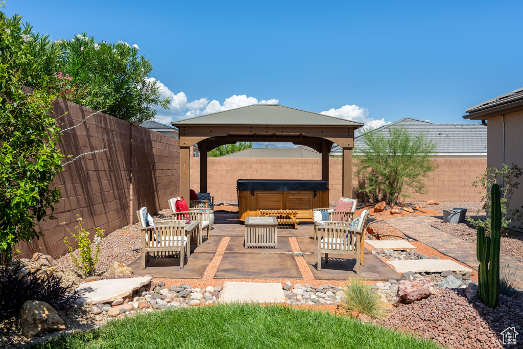 View of patio featuring an outdoor hangout area and a gazebo