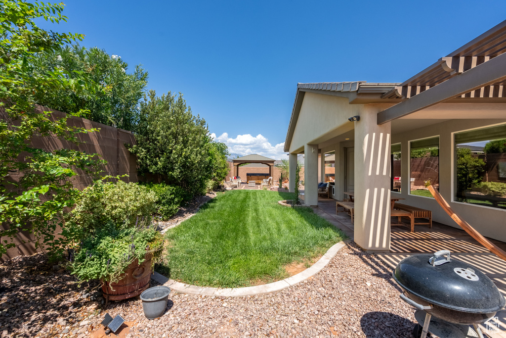 View of yard featuring a patio and a gazebo