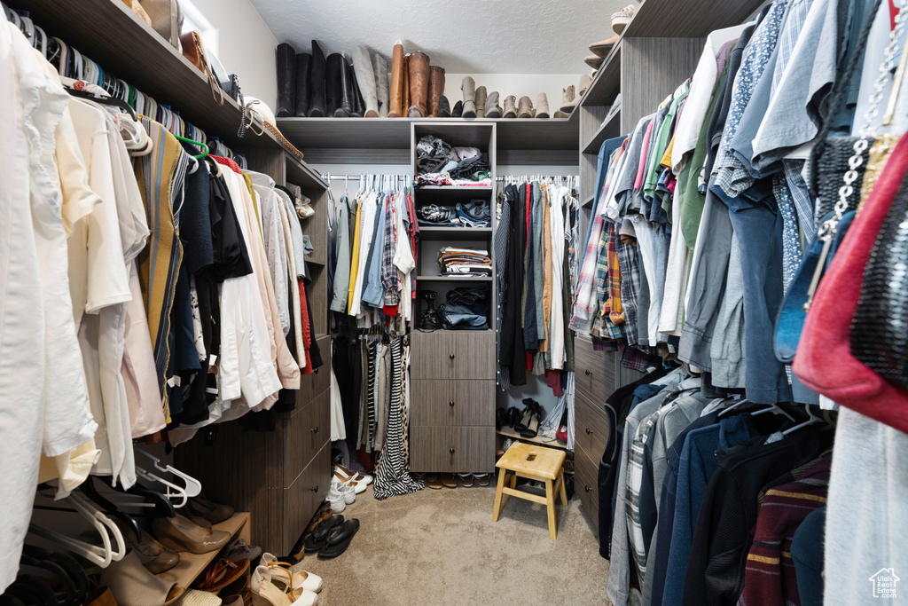 Walk in closet with light carpet