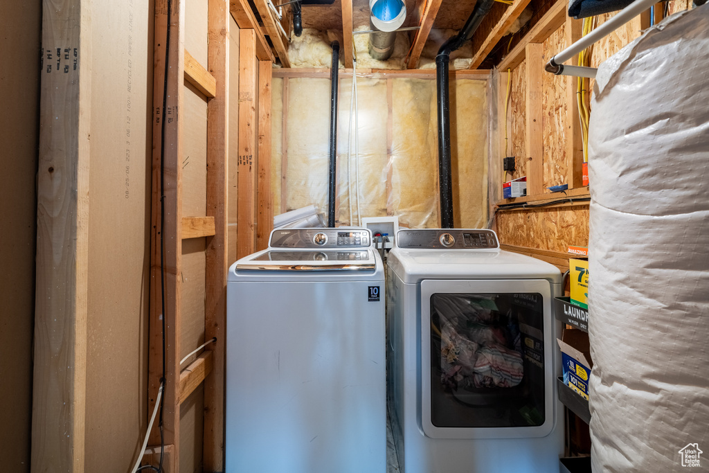 Clothes washing area featuring separate washer and dryer