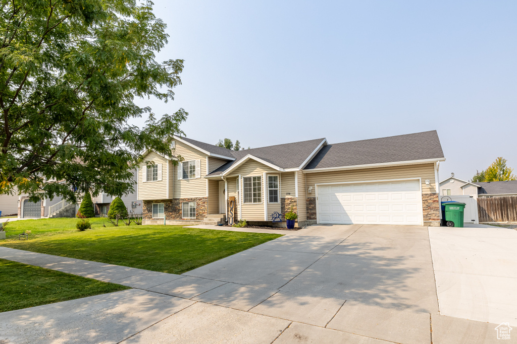 View of front of house with a front lawn and a garage