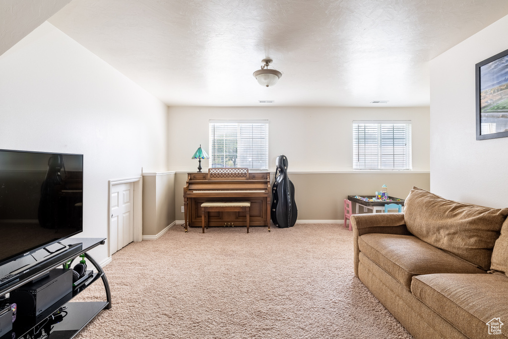 Living room featuring a wealth of natural light and light carpet