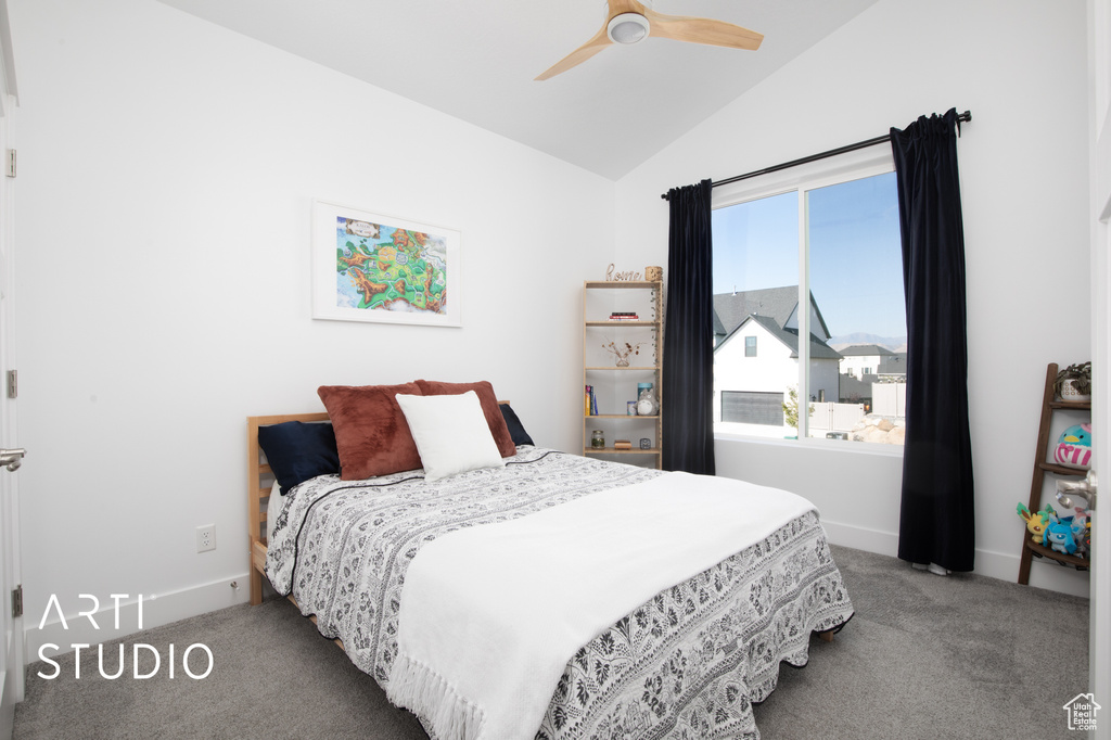 Bedroom with ceiling fan, carpet floors, and vaulted ceiling