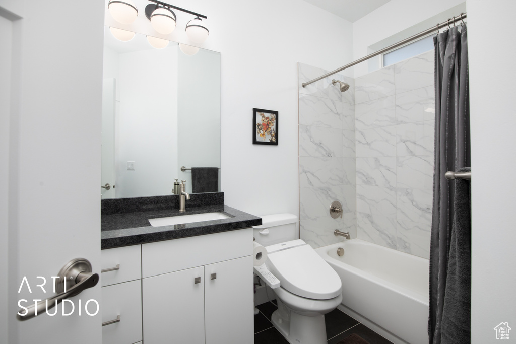 Full bathroom with vanity, toilet, shower / tub combo, and tile patterned floors