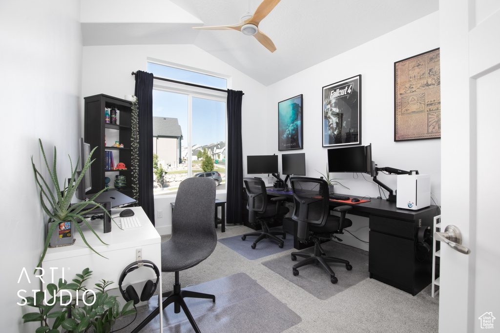 Carpeted home office featuring vaulted ceiling and ceiling fan