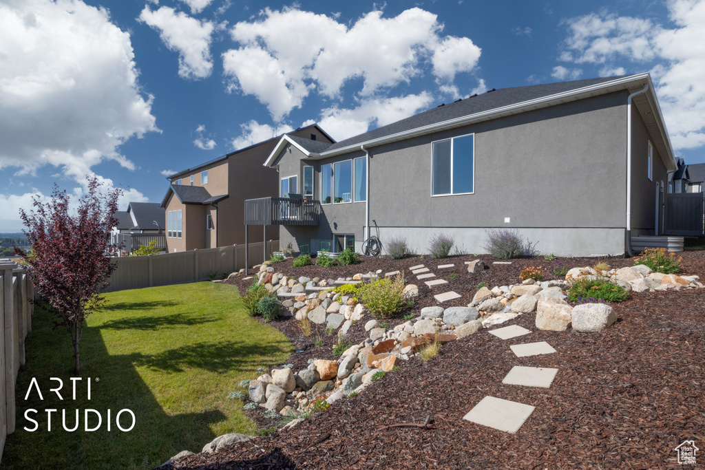 View of home\\\\\\\'s exterior featuring a balcony and a yard