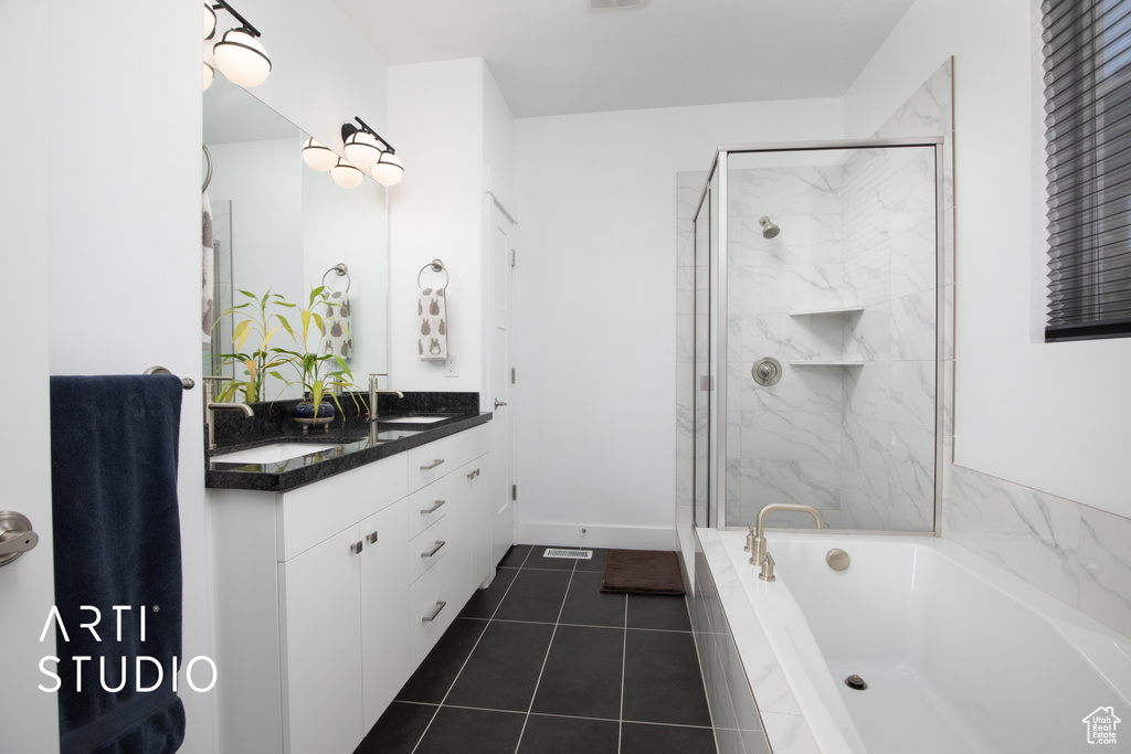 Bathroom featuring vanity, independent shower and bath, and tile patterned flooring