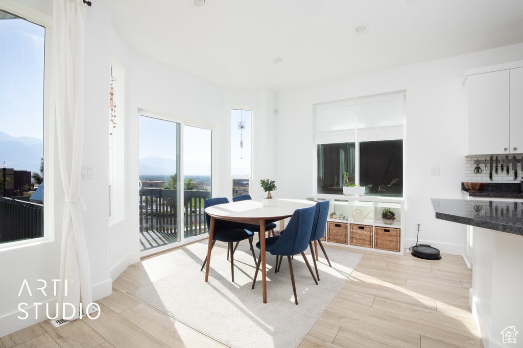 Dining area with light wood-type flooring and a mountain view