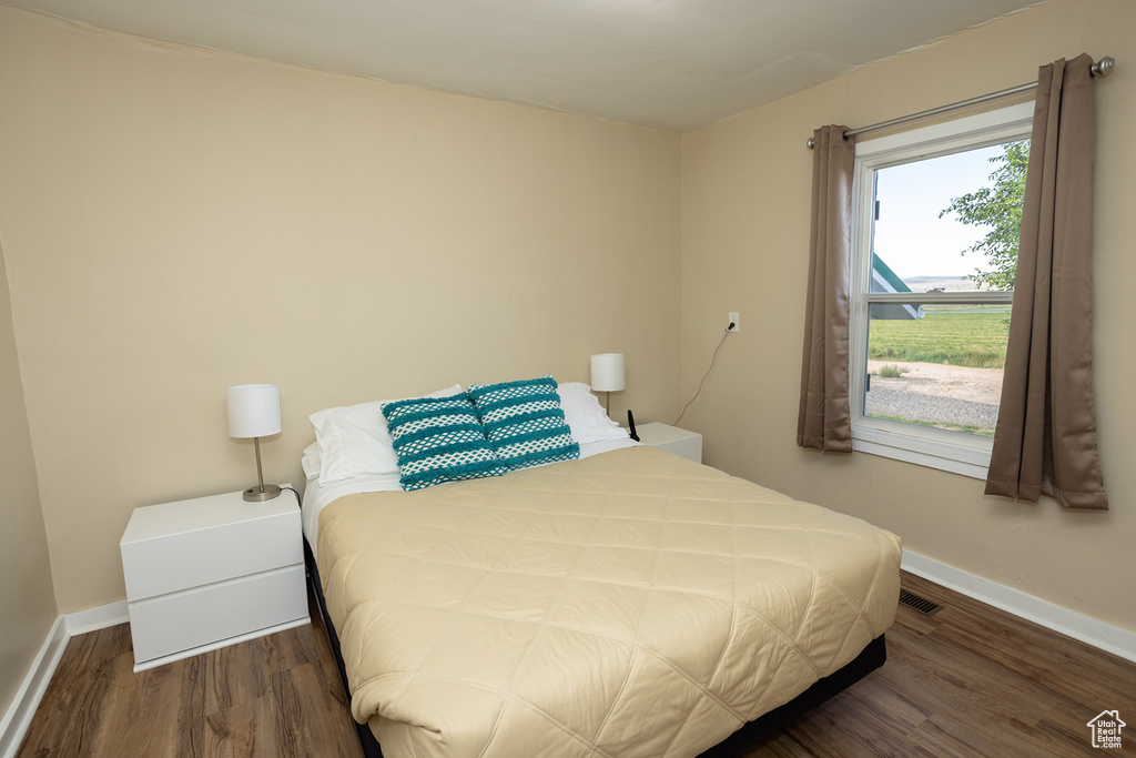 Bedroom with dark wood-type flooring