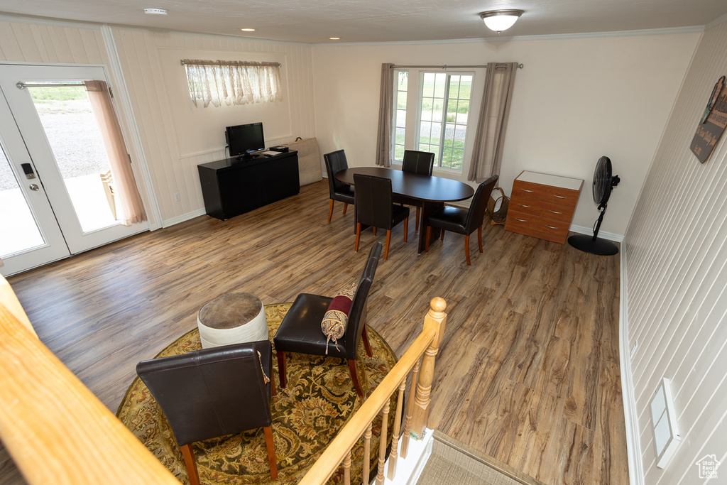 Living room featuring ornamental molding and wood-type flooring