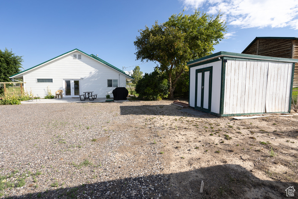 Exterior space with a storage unit, a patio area, and french doors