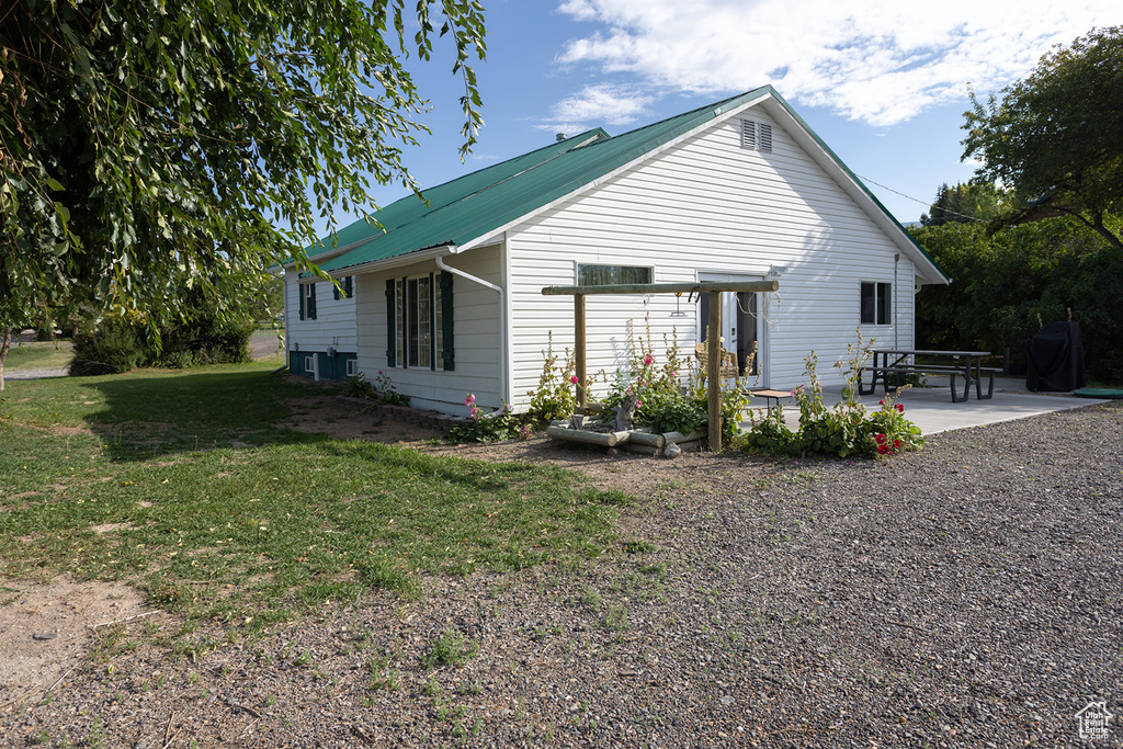 Back of house featuring a yard and a patio area