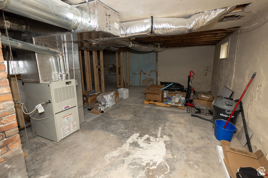 Basement featuring heating unit