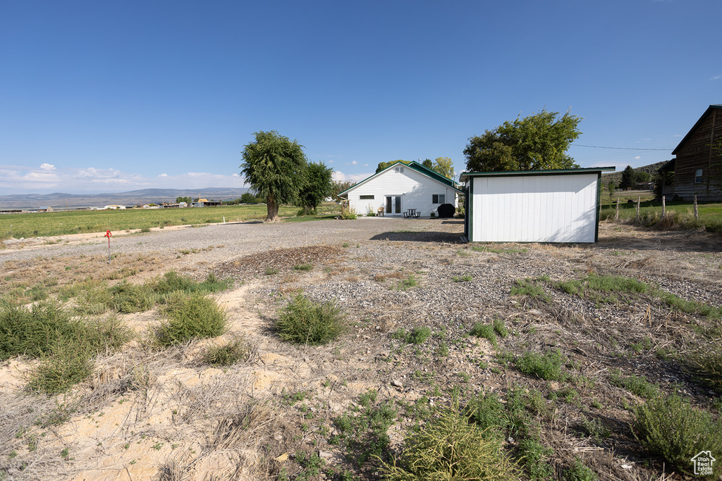 View of yard featuring an outbuilding and a rural view