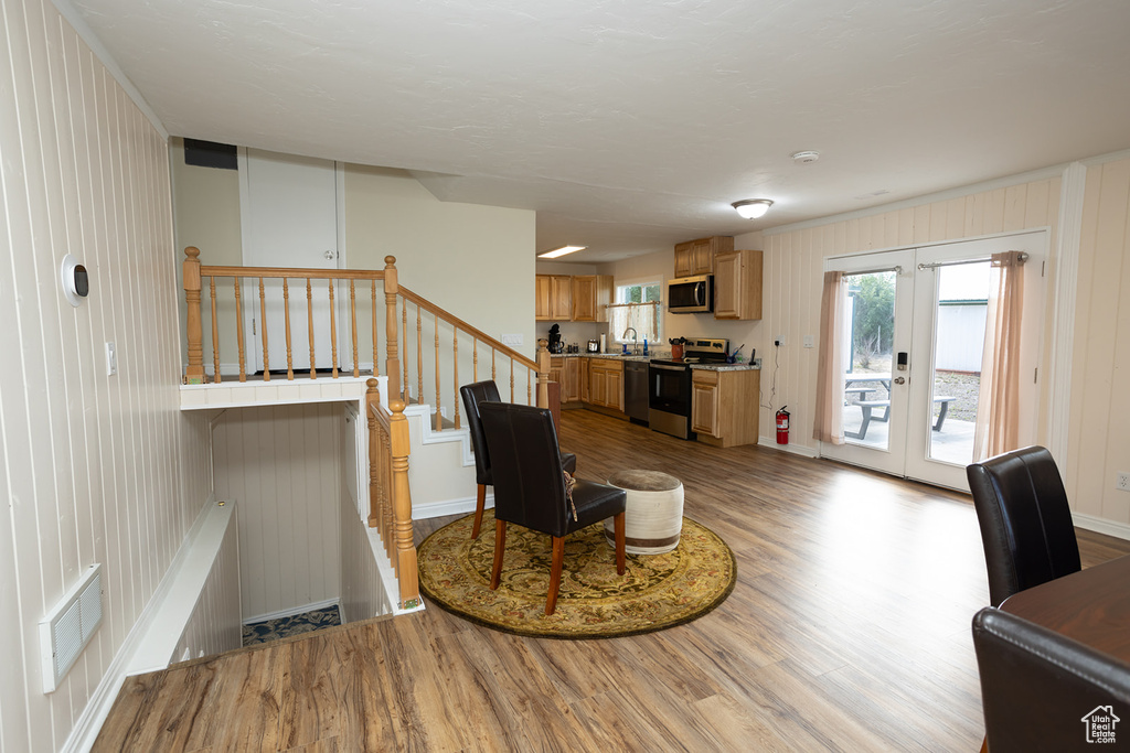 Interior space with french doors, sink, and light hardwood / wood-style floors