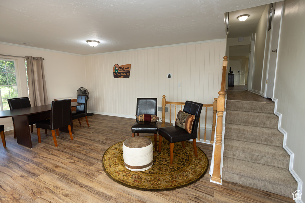 Sitting room featuring hardwood / wood-style floors and crown molding