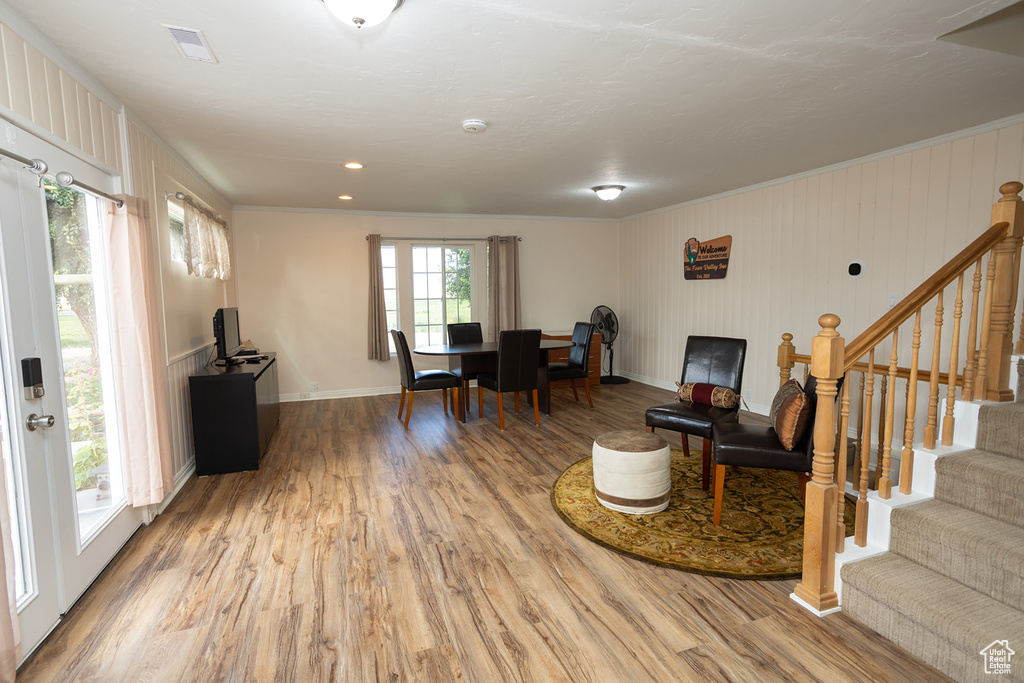 Interior space featuring hardwood / wood-style flooring and crown molding