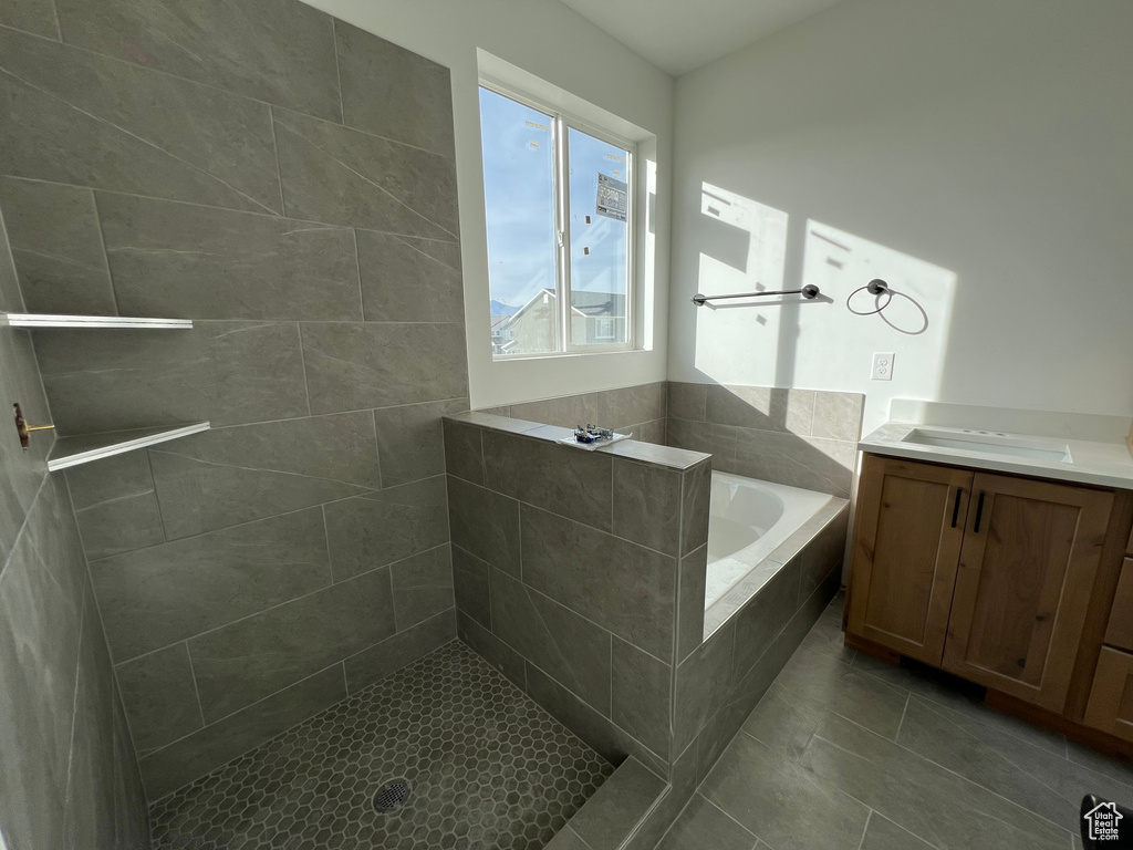 Bathroom with vanity, shower with separate bathtub, and tile patterned floors