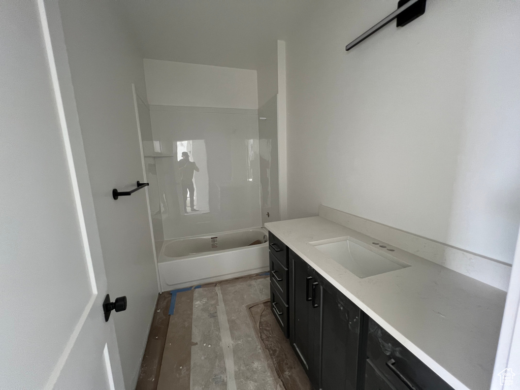 Bathroom with vanity, wood-type flooring, and shower / washtub combination