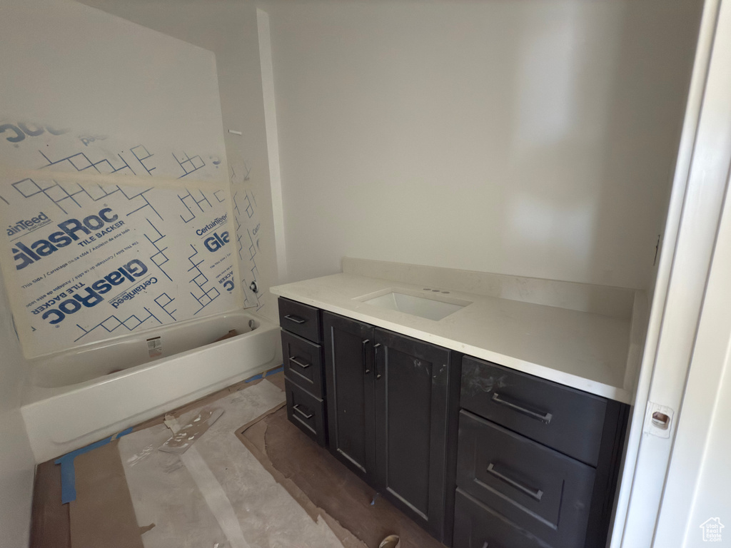 Bathroom with a tub to relax in and vanity