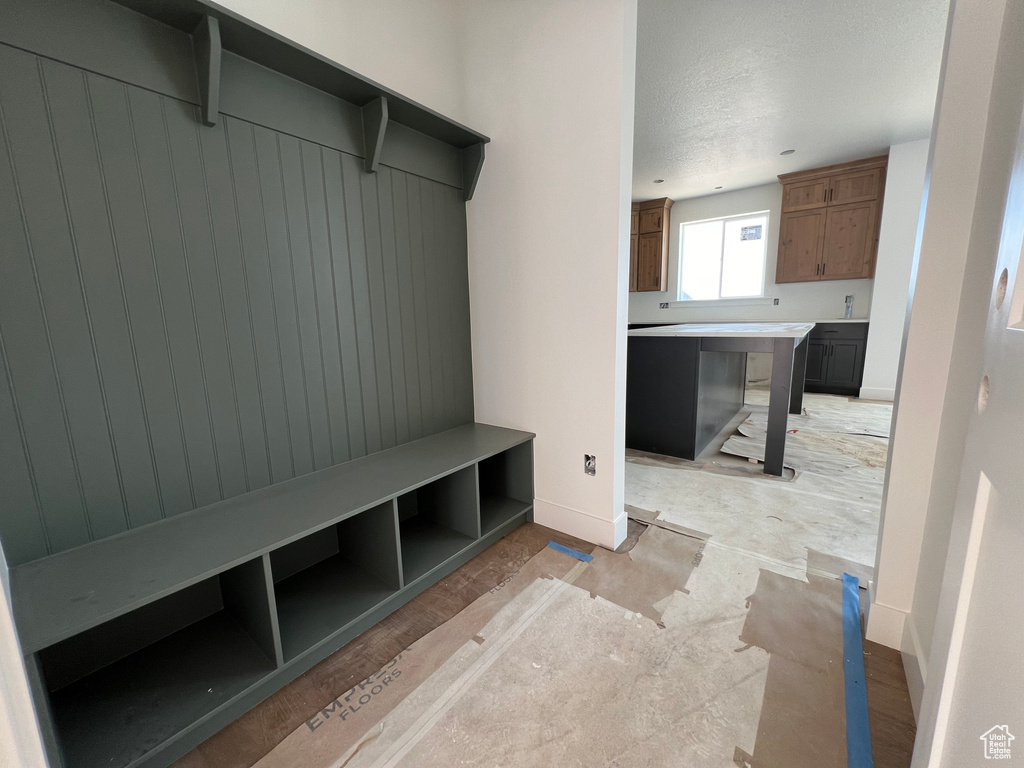 Mudroom with a textured ceiling