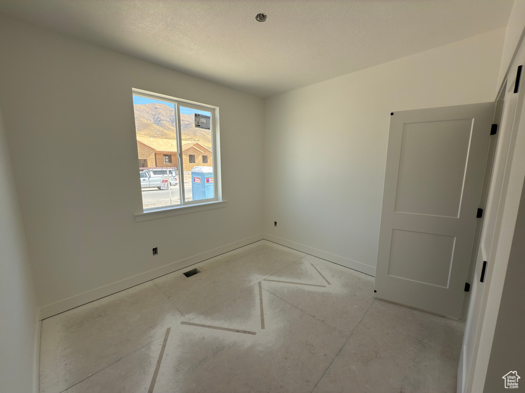 Empty room featuring a textured ceiling