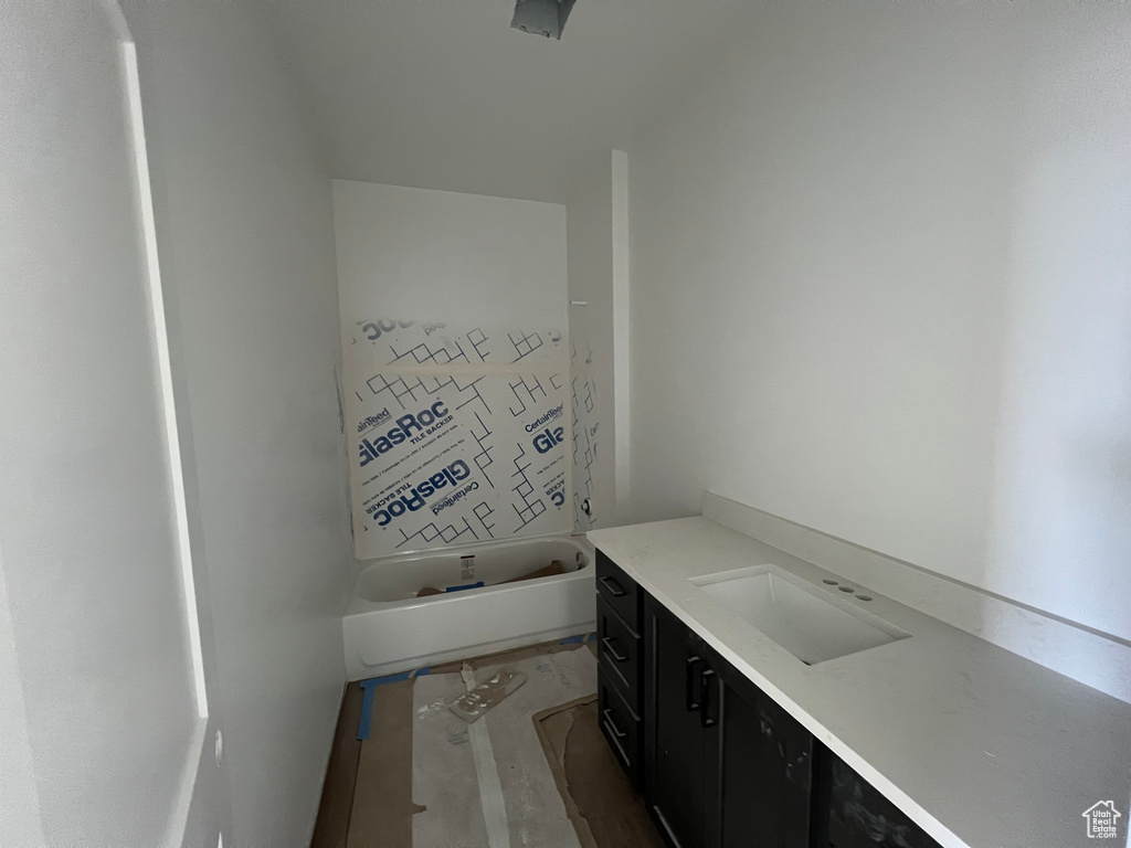 Bathroom with vanity and a bath